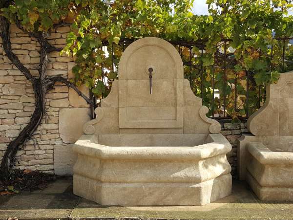 Élégante fontaine en pierre naturelle avec fronton arrondi